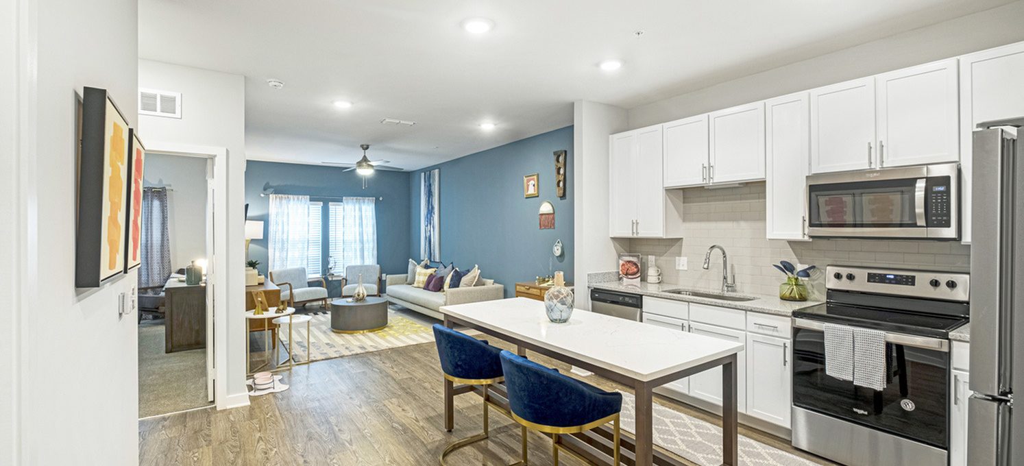 a kitchen with white cabinets and blue counter tops at The Novo Sweetwater