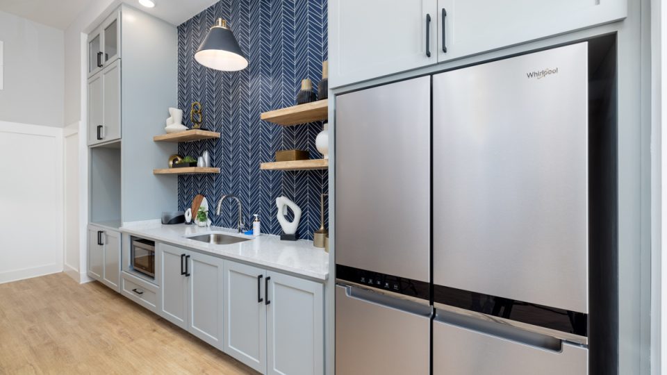 a kitchen with stainless steel appliances and blue tile at The Novo Sweetwater