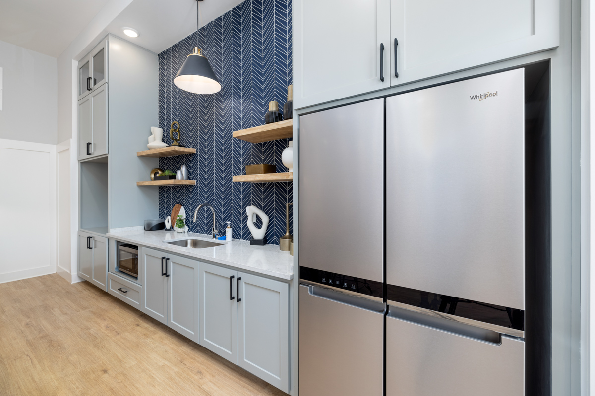 a kitchen with stainless steel appliances and blue tile at The Novo Sweetwater